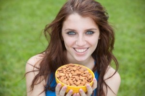 Woman holding a bowl of almonds
